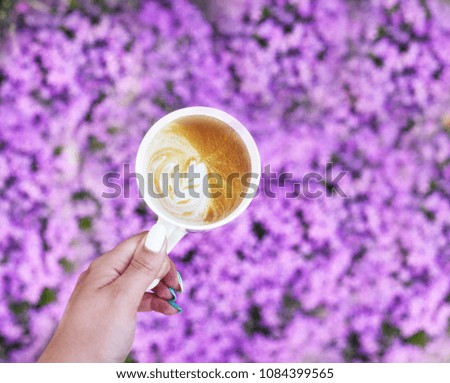 cup of cappuccino on a flower background