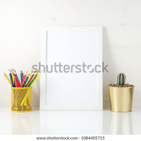 Mockup with clean white frame, colored pencils and succulent on white background. Concept for creativity, drawing.