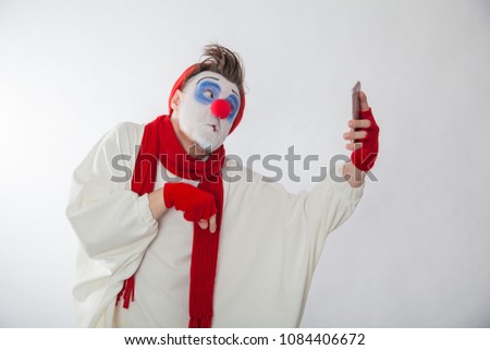 mime boy holding a phone. Human emotions. Clowns on holiday.