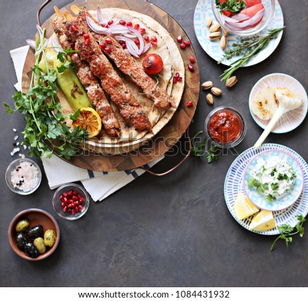  Kebab. Traditional middle eastern, arabic or mediterranean  meat kebab with vegetables and herbs. Overhead view, copy space Royalty-Free Stock Photo #1084431932