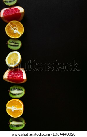 Healthy food background. Studio photo of different fruits on black table. High resolution product.