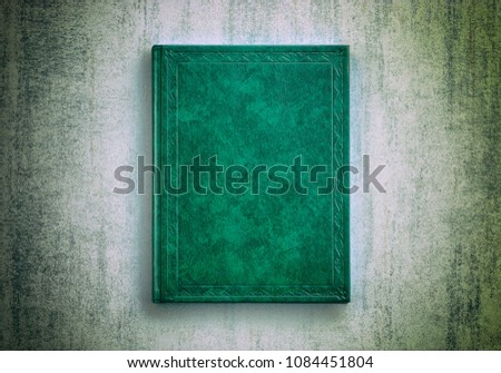 mock up book green color on grunge background close-up, top view