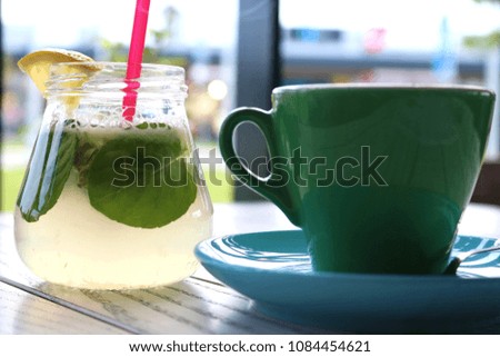     Blue and Green cup of coffee and lemonade on a white wooden table 