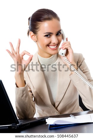 Business woman with phone showing thumbs up sign, at office, isolated over white background