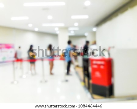 Blurred images of people queuing up counter service.