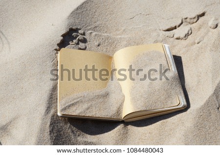 Notepad on the sand 