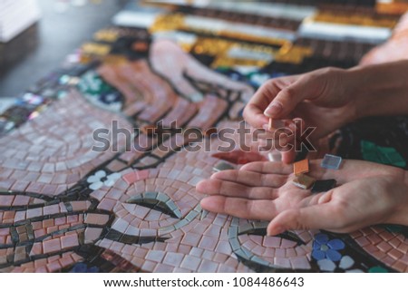 Female hands with mosaic closeup