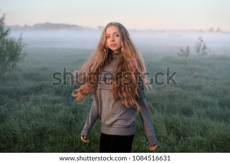 
woman with windy hair.  Morning Journey. Fog
