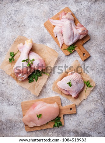 Raw chicken meat fillet, thigh, wings and legs. Top view Royalty-Free Stock Photo #1084518983