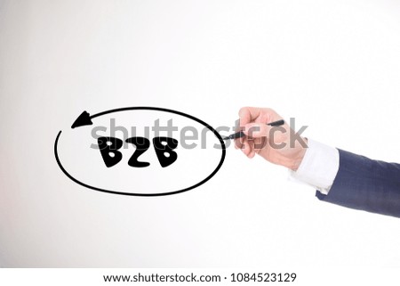The businessman writes a black marker inscription:B2B