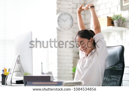 Businesswoman Relax from work. At the office Royalty-Free Stock Photo #1084534856