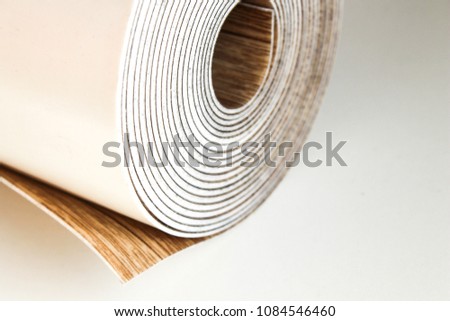 Roll of linoleum on a white background