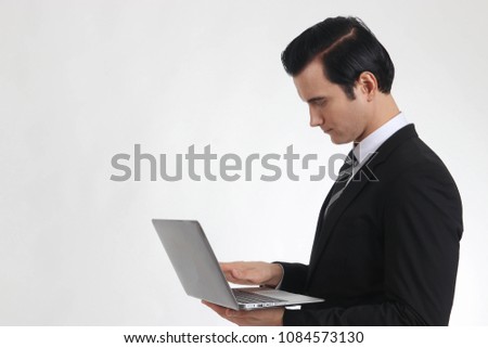 Businessmen use computers on a white backdrop.