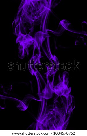 Smoke the purple incense on a black background. darkness concept