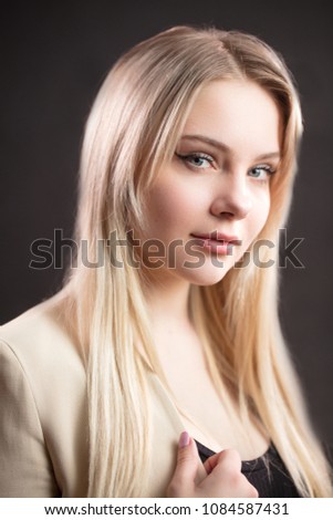 Confident professional sales manager female with beautiful catty eyes, looking at camera, isolated on black background, woman cloth