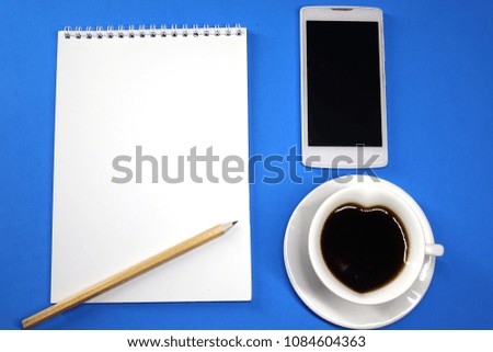 Notepad, coffee and phone on colored background top view, school, business, education