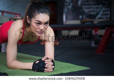 Beautiful asian woman play fitness in the gym,Thailand girl has a slim body,Time for exercise,People love heath,Stretching body before workout,Sport woman warm up body,Planking exercise