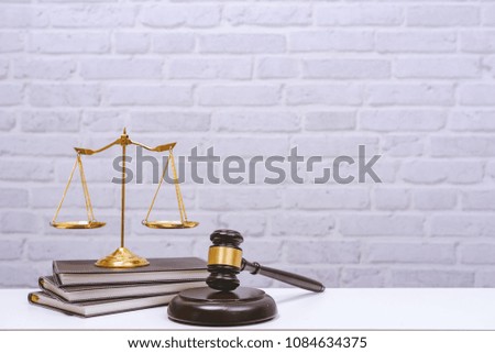 Workspace for lawyer with laptop blank screen and wooden gavel , legal law on wood table in office. Workspace background and desk work mockup concept.