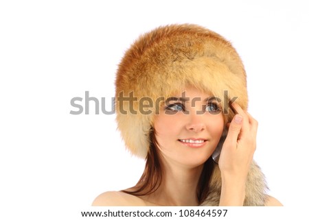 Close up portrait of young beautiful girl in fur hat over white background