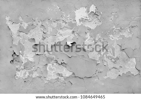 Flaking paint on an old concrete wall. Gray background. Texture. Royalty-Free Stock Photo #1084649465