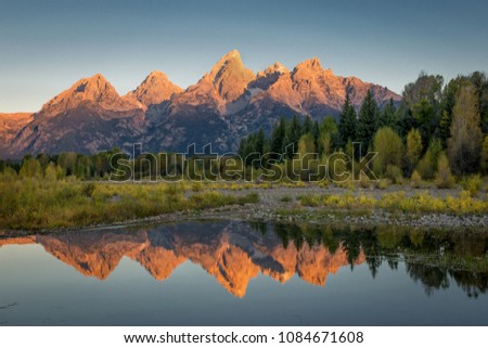 Sunrise on the Grand Teton mountain range with the Snake River in foreground