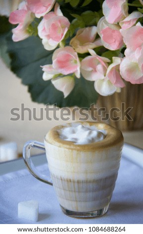 close up of coffee cream in glasses cup on the table, vertical