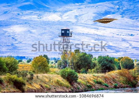 UFO flies to the tower, observation post on the border between Armenia and Turkey and a man welcomes aliens.  3D illustration