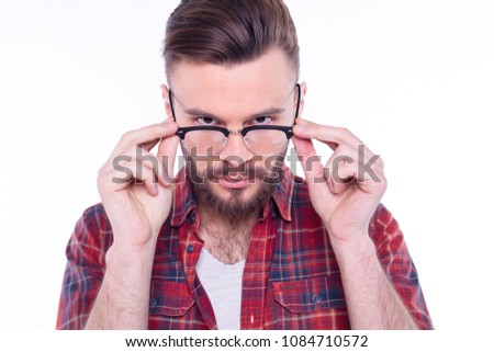 Man Holds on Glasses and Looking on Camera. Stylish Bearded Handsome Man with Glasses and in Checkered Shirt Isolated on White.