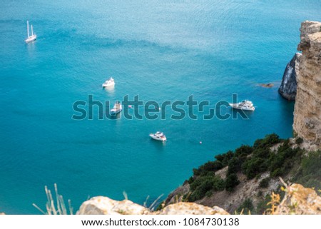 the rocky islands. high rocky cliff and boats at sea. Aerial view