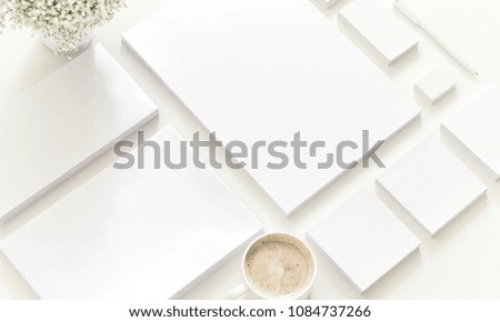White workspace. Empty white stationery with a coffee and plant. Mock-up for branding identity. Corporate identity set. Flat lay, top view, copy space