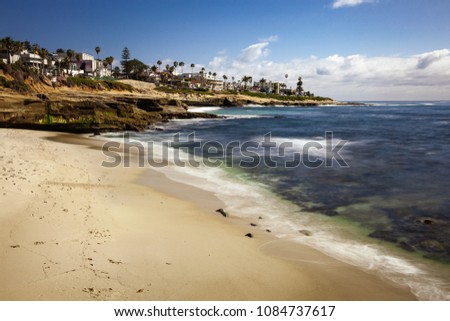 Beautiful long exposure landscape and seascape of a coastal beach in La Jolla California on a bright sunny day.