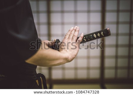 Japanese martial arts athlete training kendo in a dojo - Samaurai practicing in a gym Royalty-Free Stock Photo #1084747328