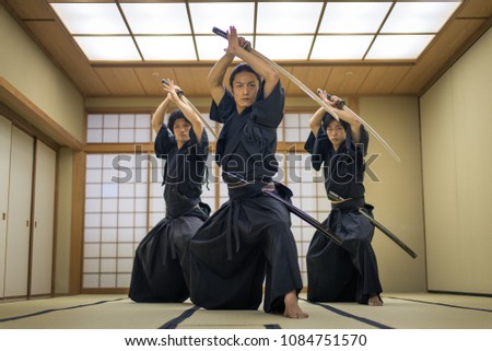 Japanese martial arts athlete training kendo in a dojo - Samaurai practicing in a gym Royalty-Free Stock Photo #1084751570
