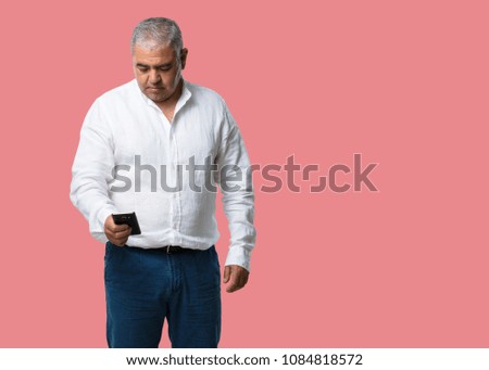 Middle aged man closeup of hand touching a mobile, using internet and social networks, positive feeling of future and modernity