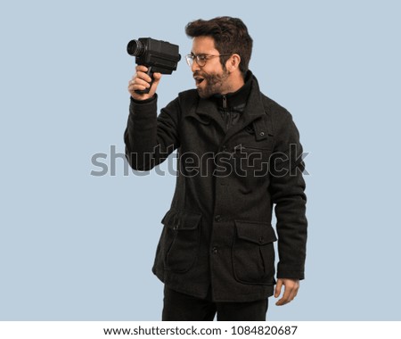 young man holding a video camera