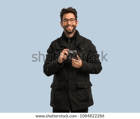 young man holding a camara