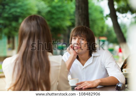 guy is bored on a date with a girl in a summer cafe Royalty-Free Stock Photo #108482906