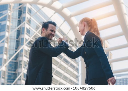 business woman fighting with business man thwart with hand pull hand wrestle for winner. business fighting to success concept.