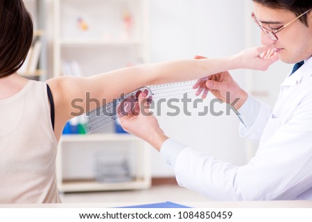 Doctor checking patients joint flexibility with gonimeter