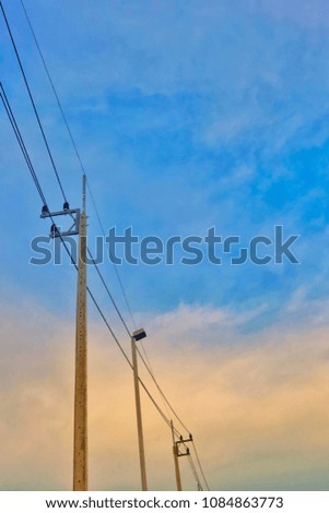 Electric pole and cable lines in Thailand with blue sky and clouds
