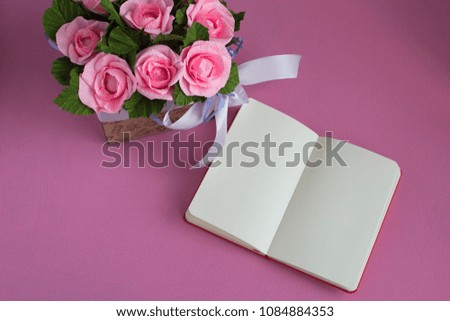Mockup with sketchbook and flowers. Bouquet of pink roses with open Notepad on pink background. Flat style.