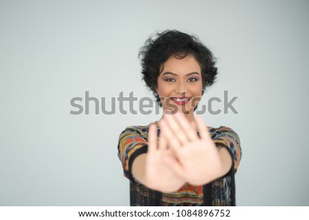 woman showing her hand  cover her face on white background
