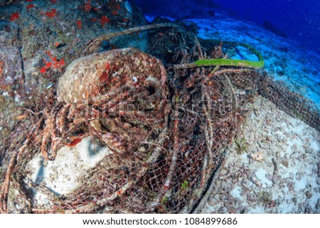 Abandoned fishing equipment polluting a tropical coral reef