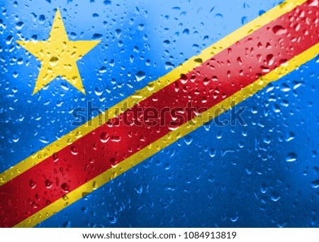 Texture of Democratic Republic of the Congo   flag on the glass with drops of rain.