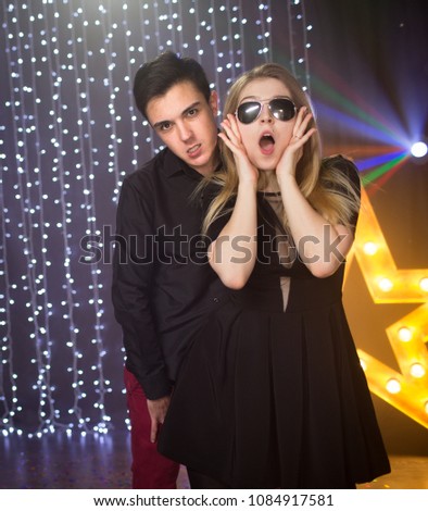 A couple of dancing people at a disco, party