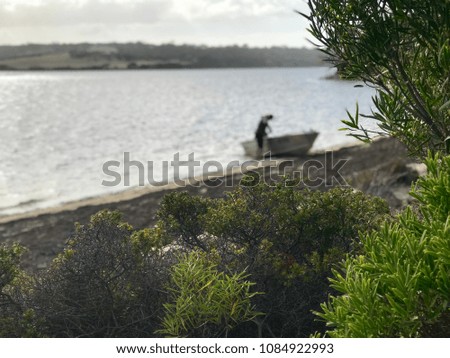 Man with his boat in Pelican lagoon on kangaroo island