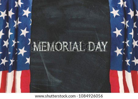 Picture of memorial day word on the blackboard with curtain of an American flag