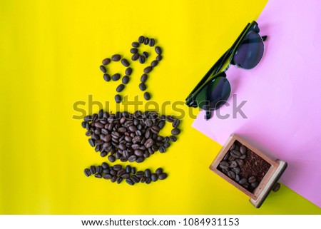 top view flat layer coffee beans in cup and smell icon shape and sun glasses on two tone multicoloured background