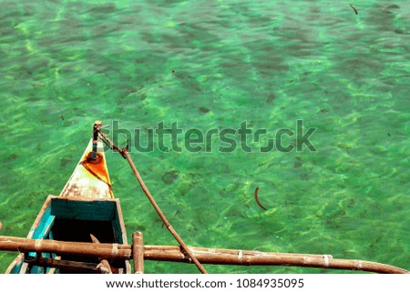 Pristine clear waters seen from an outtrigered canoe during island hopping trip