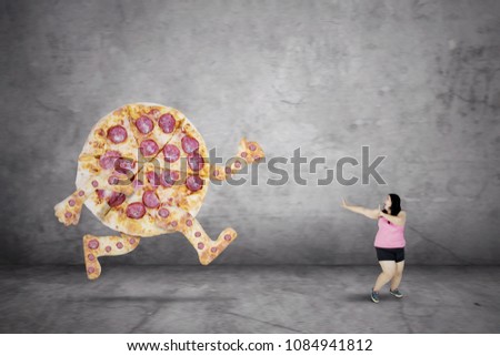 Picture of fat woman being chased by a tasty pizza  while running with fear expression